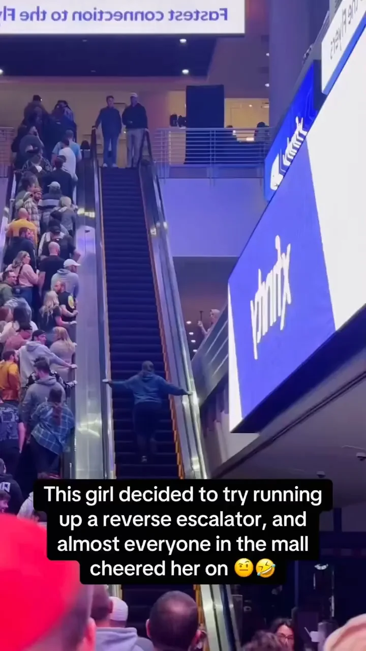Girl Attempts to Run Up Reverse Escalator, Mall Crowd Cheers Her On thumbnail