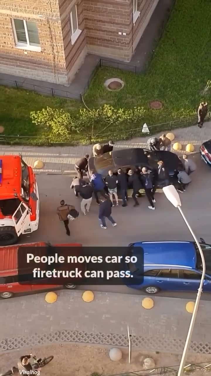 People moving a car so the fire truck can pass!