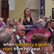 A nervous couple are waiting to get married when suddenly a guest rises from her seat