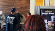Guy throws drink contents at another man in McDonald's and immediately regrets it